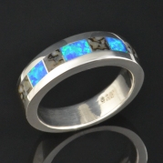 Dinosaur bone and lab created opal man's wedding band in sterling silver.